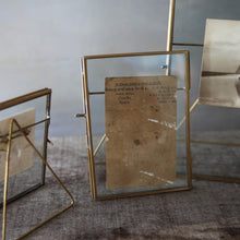Load image into Gallery viewer, Our Danta antique black frame has a stunning finish that frames a photograph perfectly. The hand-forged metal framework and stand surrounds the elegant glass aperture.