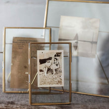 Load image into Gallery viewer, Our Danta antique black frame has a stunning finish that frames a photograph perfectly. The hand-forged metal framework and stand surrounds the elegant glass aperture.
